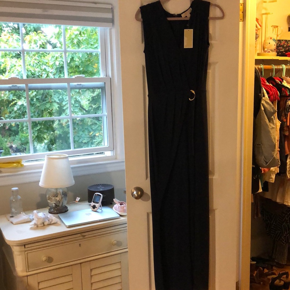 Michael Kors Navy blue jumpsuit with gold belt buckle detail.